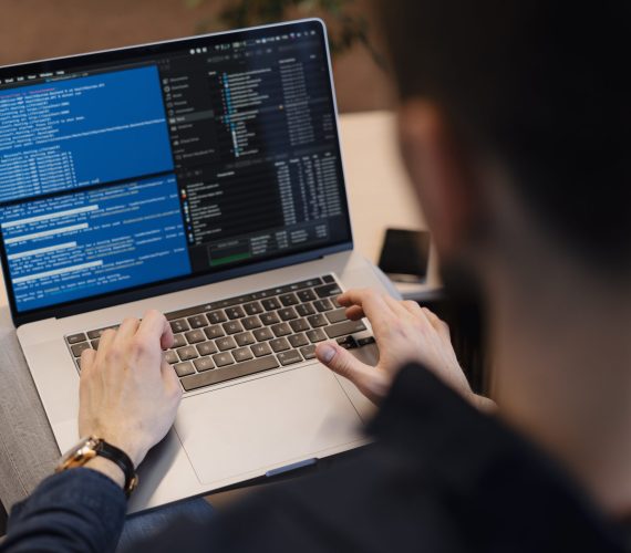 Man working on computer. Young it worker using laptop in the office, Internet marketing, technology, finance, business concept